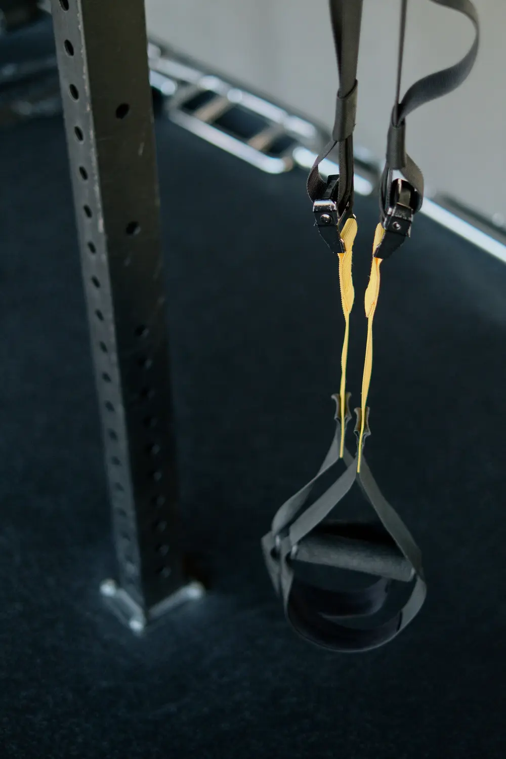 Yellow suspension straps hanging from a dark rig